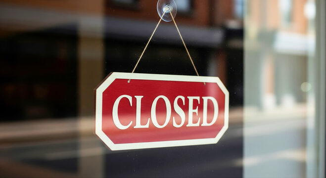 Closed Sign on Glass Door Symbolizing Business Closure and Economic Recession