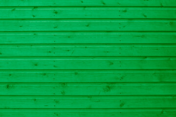 Background image of green wood shiplap panel side of a garden shed. Outdoor wooden panelling background