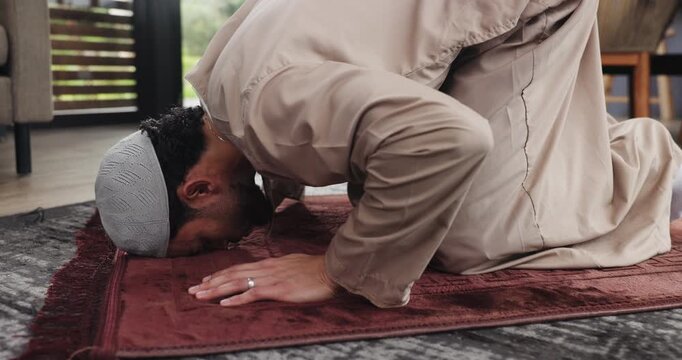 Muslim, man and praying with mat on floor, worship or faith with respect, devotion and Islamic belief. Bow, prostrate or male person with trust in Allah, God and prayer with Islam in the home