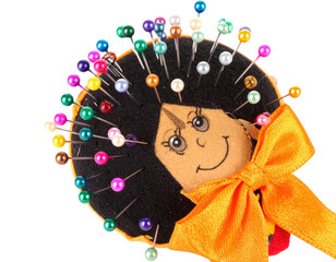 Whimsical Pin Cushion Doll with Colorful Pins and Bow.