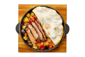 boiled pork with vegetables stewed in a frying pan