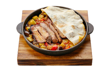 boiled pork with vegetables stewed in a frying pan