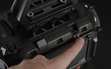 A human finger carefully presses an operational button.