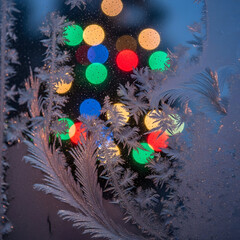 Frost Pattern on Window with Bokeh Lights Background