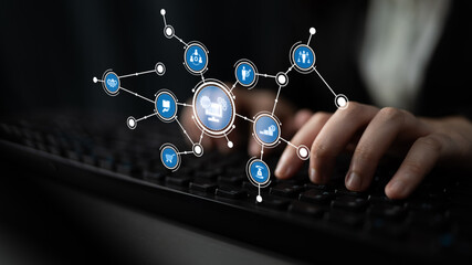 A close-up view of hands typing on a keyboard, accompanied by illuminated digital interface icons that symbolize modern technology and connectivity in professional settings. Tessel
