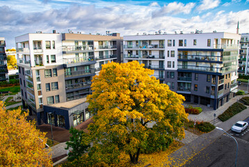 New modern residential block buildings and autumn park. Housing development in Europe	