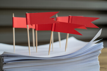 red flags on paperwork symbolizing warning and risk in documents