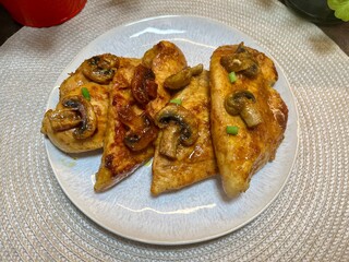 Grilled chicken topped with mushrooms and vegetables. Homemade comfort food or breakfast meal