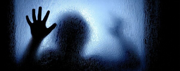 A shadowy figure presses against a frosted glass surface, creating an eerie and mysterious effect with a haunting atmosphere.