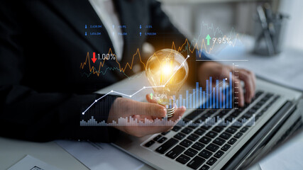 A business professional analyzes data trends and insights on a laptop, showcasing financial growth symbols and a lightbulb moment in a modern office environment. Scalp