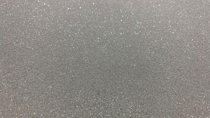 Sparkling glittery silver surface, perfect for backgrounds, crafts, or adding a touch of festive shine