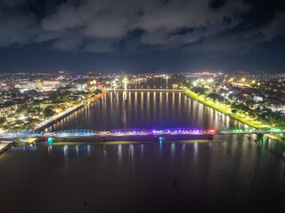 Panoramic view of Truong Tien Bridge in Hue City at night. Bridge illuminated all over with blurry reflection on. Travel and landscape concept