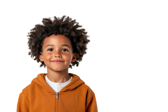 A cheerful young boy with curly hair wearing a cozy hoodie, smiling confidently against a white background.