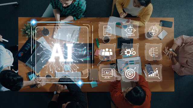 Aerial view of a diverse group engaged in a business meeting, discussing artificial intelligence concepts with modern tools and technology on a sleek office table. Trope