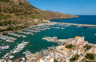 Fototapeta premium Aerial view of Castellammare del Golfo, a town located in the province of Trapani, Sicily, Italy. It has a small marina overlooking the Tyrrhenian Sea, crowded with many boats every summer.