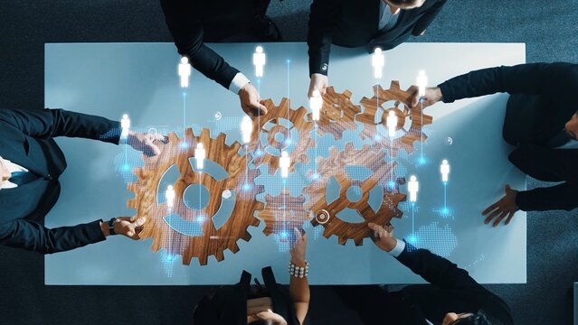 A diverse team of professionals collaborates on an innovative project, interacting with gears and digital technology, symbolizing teamwork and strategic success. Raster - Powered by Adobe