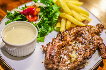 Delicious Gourmet Grilled Steak with Salad and French Fries Cuisine