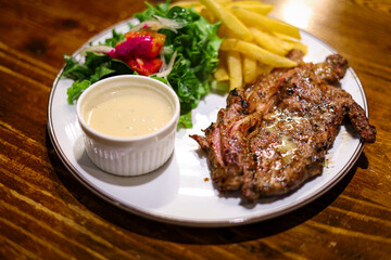 Appetizing Grilled Steak with Fresh Salad and Crispy Fries on Plate