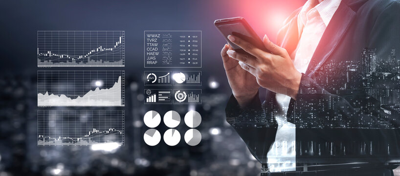 A business professional stands in a modern urban environment, using a smartphone while analyzing financial data and performance charts, representing growth and success. Impute - Powered by Adobe