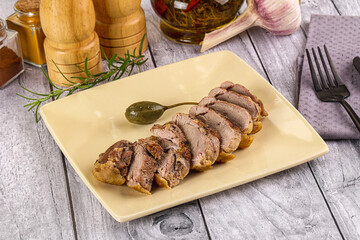 Roasted duck breast slices in the plate