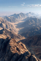 Obraz premium Majestic mountain landscape showcasing rugged peaks and valleys under a clear blue sky, highlighting the beauty of nature and the vastness of the wilderness