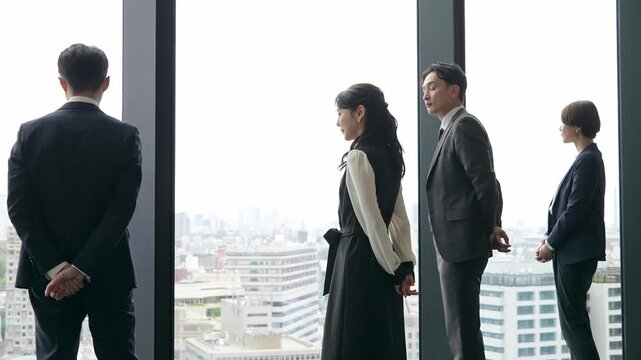 Group of business people looking out from their office