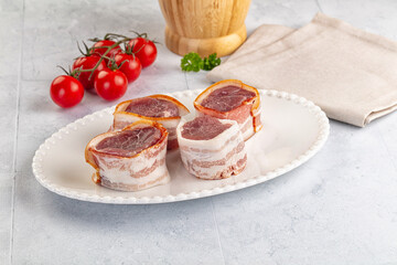 Raw pork tenferloin with bacon