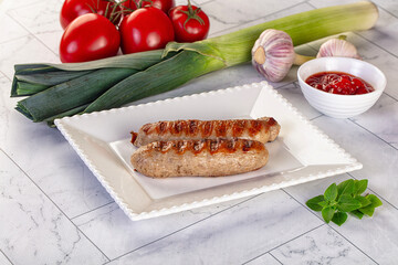 Grilled pork sausages served tomato sauce