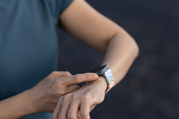 Woman is using her smartwatch to check her data after finishing her run