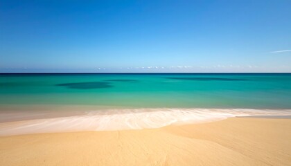 Fototapeta premium A sun-drenched, pristine beach with turquoise water meets a clear blue sky in a serene, idyllic seascape