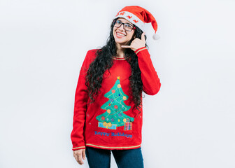 Young woman in Christmas sweater making call me gesture isolated. Beautiful girl in Christmas...