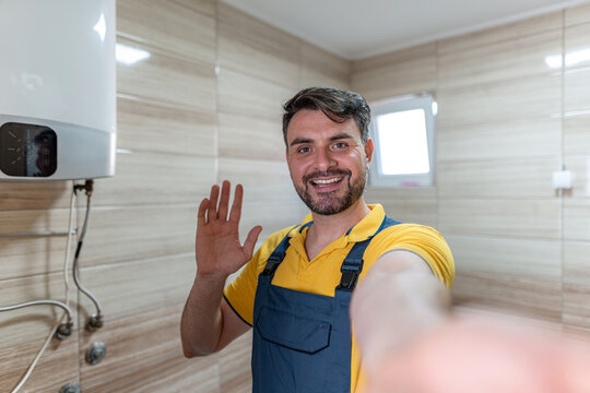 Friendly technician waving during home repair work in modern bathroom space - Powered by Adobe