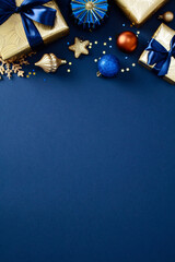 Modern Blue Christmas vertical background with gold wrapped gifts, balls, glittering confetti. Elegant Christmas greeting card design, Happy New Year poster template