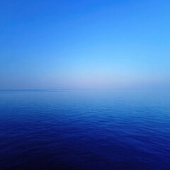 Obraz premium Serene, dark blue sea meets the pastel blue sky on the horizon