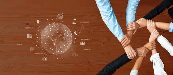 Hands from diverse individuals unite in collaboration over a global concept illustration, symbolizing teamwork, support, and shared goals in a professional setting. Trope