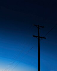 Abstract Graphic Featuring Silhouette of Power Pole Against Deep Blue Sky