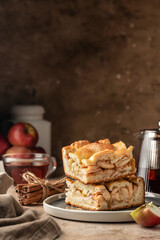 Homemade Apple Pie with fresh apples sliced on brown kitchen background with text space. Thanksgiving traditional dessert, autumn baking, recipe