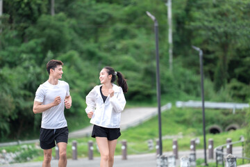 Young couple enjoying healthy jogging outdoors © Phimwilai