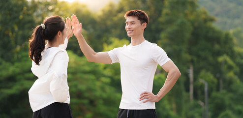 Young couple celebrating success with high five