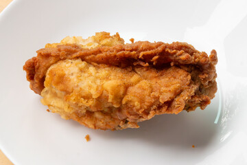 crispy fried chicken on white plate close up