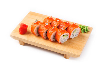 Delicious sushi rolls served on a wooden board with garnishes