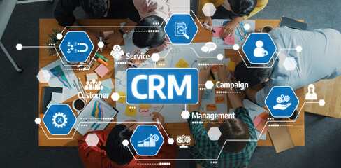 A diverse team engages in a collaborative workspace, focusing on customer relationship management. The group utilizes various strategies and tools for effective teamwork and innovation. Amity