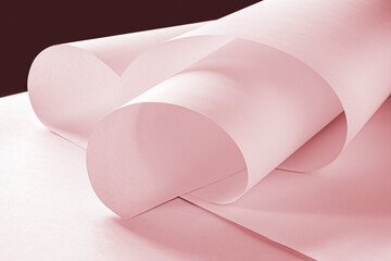Long sheets of paper from a roll of pink tone.