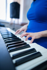 Caucasian woman playing electric piano. 