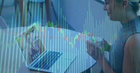 Woman holding coffee mug at office table facing laptop showing call with overlaid chart, copy space