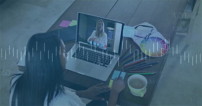 Taking notes graphic designer writing at home office desk, with laptop and color wheel, copy space