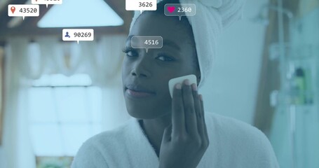 Applying cotton pad woman wearing bathrobe wiping cheek at bathroom mirror, with social media icons