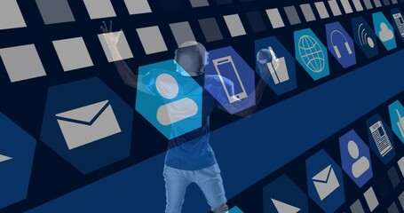 Exploring African American male using VR headset, motion controllers in grid, floating icon panels