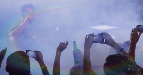 Singing African singer holding mic on hazy concert stage, with phones bottle flares, copy space