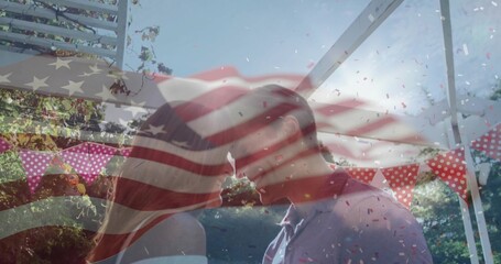 Couple in formal wear kissing under pergola in garden, with pennant banners, confetti, flag overlay